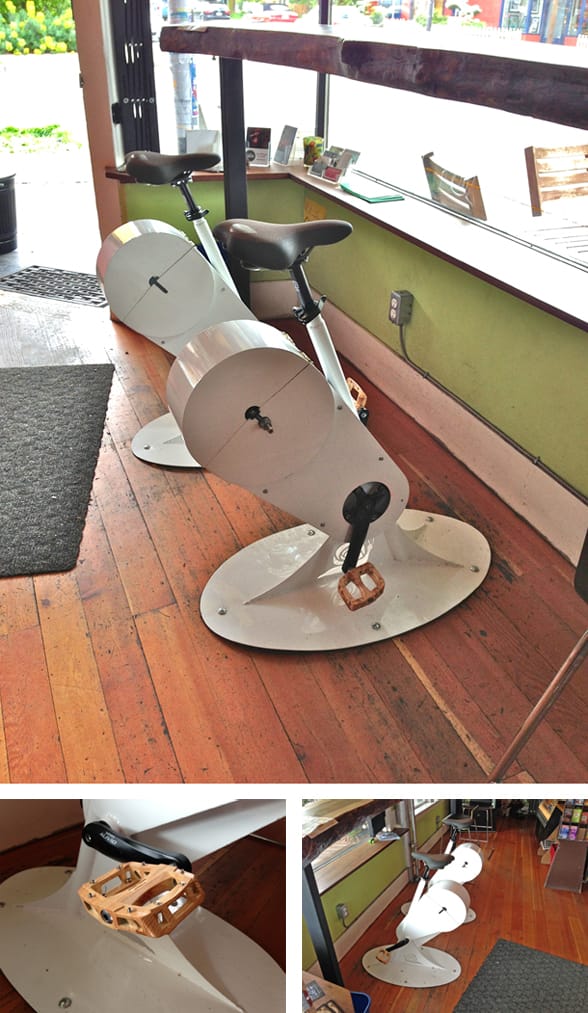 Close view of a gSnails stool with its wooden pedal and snail-shell flywheel inside the café